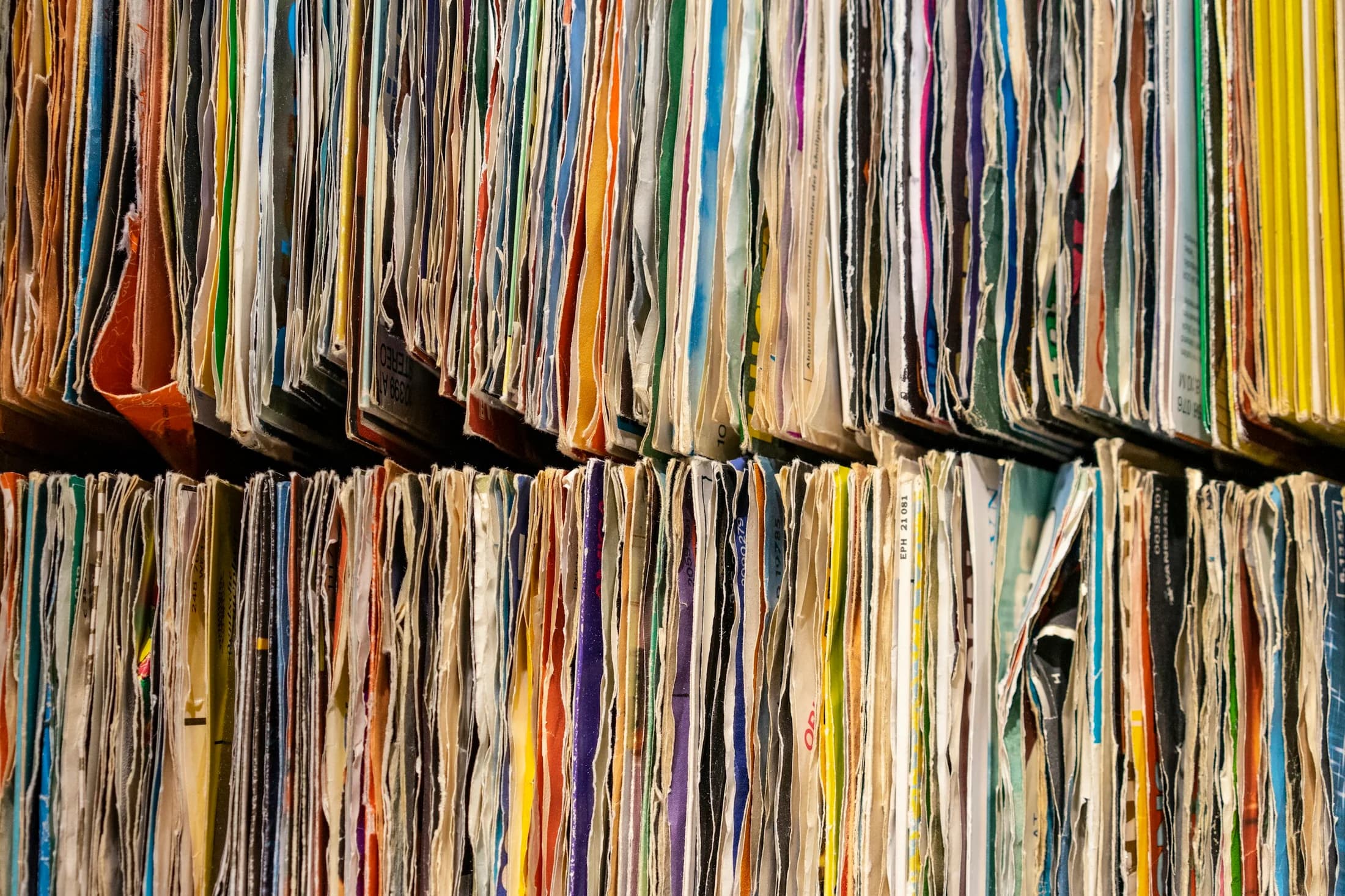 Rows of paper records arranged tightly on archive shelves
