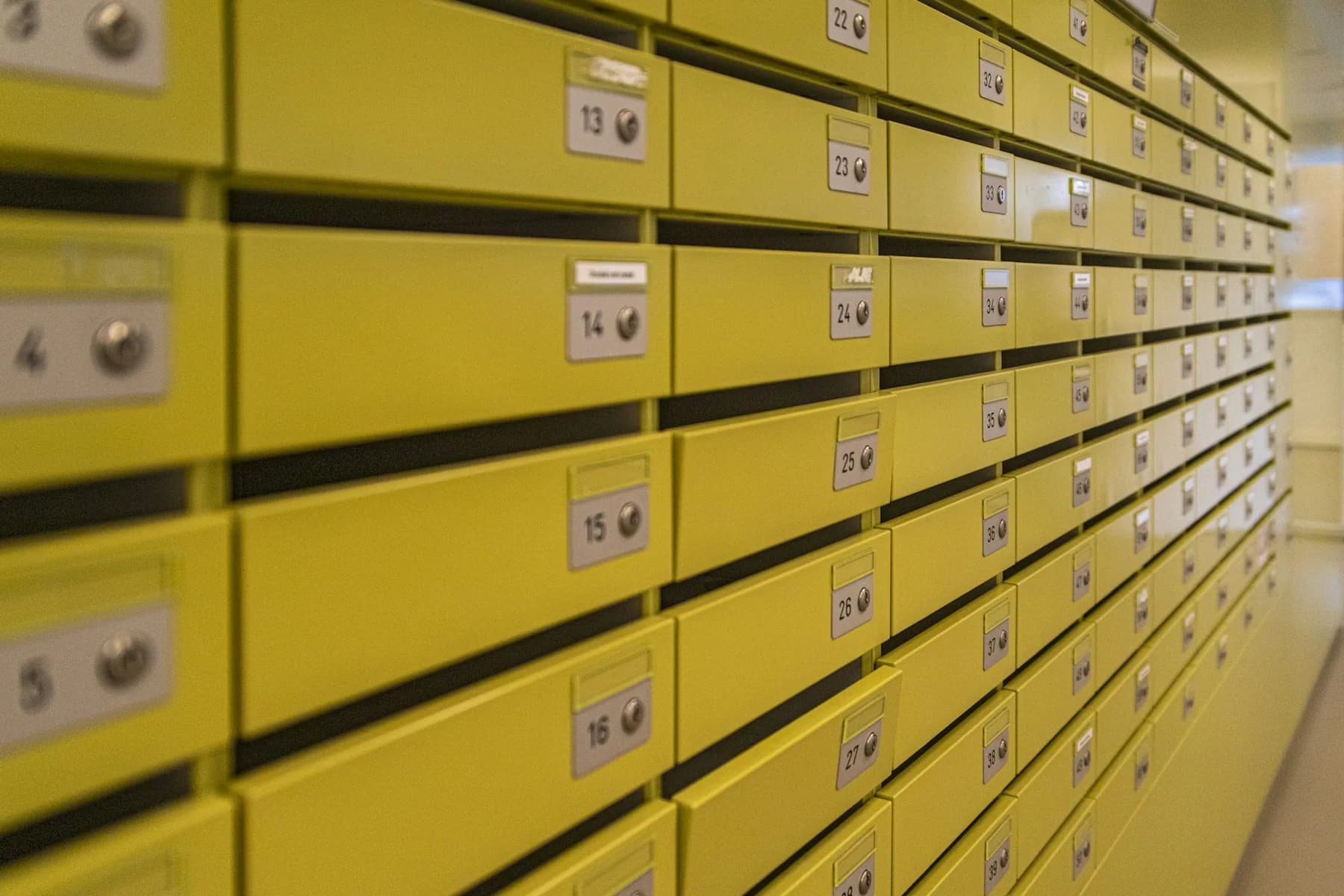 A long row of yellow archival filing drawers
